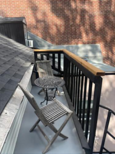 a chair and a table on a balcony at L'Hotel Particulier Griffintown in Montréal
