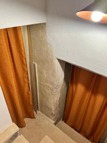 a corner of a room with an orange curtain at DIMORE DE SANTIS in Andrano