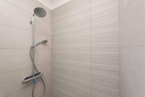 a shower with a shower head in a bathroom at Apartment Birgir in Sukosan in Sukošan