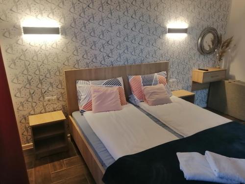 a bedroom with a bed with two pillows on it at Vila Vista Magica Radozda in Struga