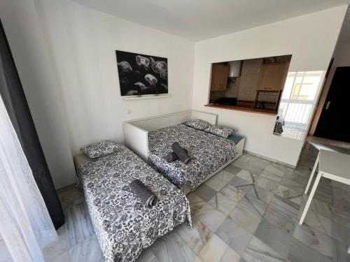 Posteľ alebo postele v izbe v ubytovaní Genuar Apartments Málaga Center 3
