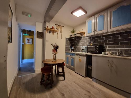 a small kitchen with a table and a counter at THE PRINCE OF GREENWICH Museum Pub in London