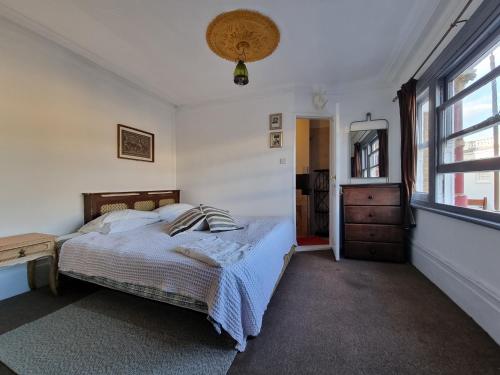 a bedroom with a bed and a window at THE PRINCE OF GREENWICH Museum Pub in London