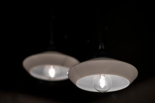 two lights hanging from the ceiling in a dark room at Villa9centob&b in Castel di Lama
