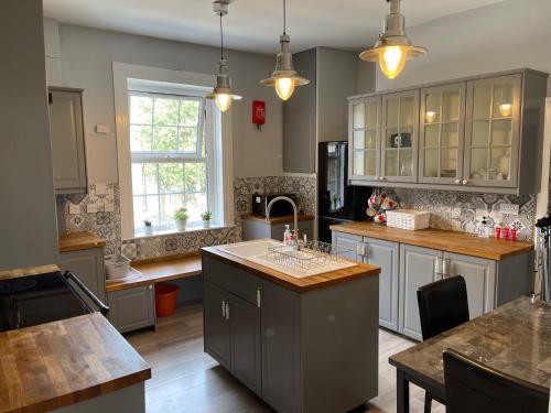 a kitchen with an island in the middle of it at Spacious 4-bed Holiday Home in the heart of Maidstone in Maidstone