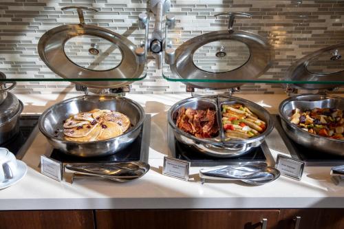 a buffet of different types of food on a counter at Sonesta San Jose - Milpitas in Milpitas