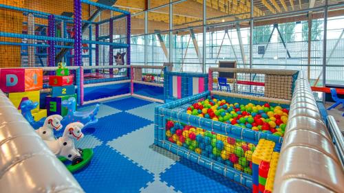 a large indoor play room with toys and slides at Hotel AquaCity Seasons in Poprad