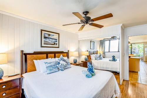 a bedroom with two beds and a ceiling fan at Polynesian Shores 118 in Kahana