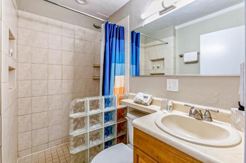 a bathroom with a sink and a toilet and a shower at Polynesian Shores 118 in Kahana