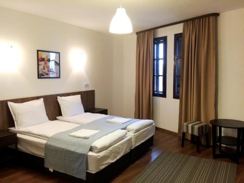 Una habitación de hotel con una cama en una habitación en White House, en Veliko Tŭrnovo