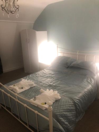 a bedroom with a bed with towels on it at The Mayfair Hotel in Great Yarmouth