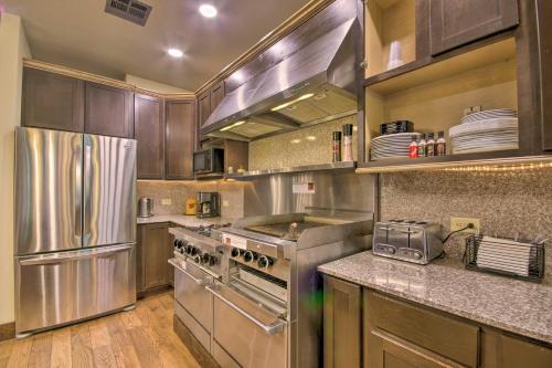 a kitchen with stainless steel appliances and wooden cabinets at Dragon Castle with Secret Passage, Dock, and Hot Tub in Camdenton