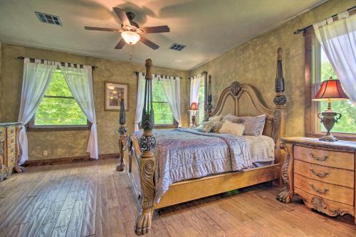 a bedroom with a bed and a ceiling fan at Dragon Castle with Secret Passage, Dock, and Hot Tub in Camdenton