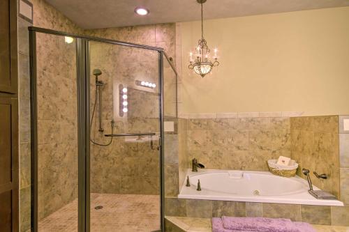 a bathroom with a tub and a shower with a chandelier at Dragon Castle with Secret Passage, Dock, and Hot Tub in Camdenton