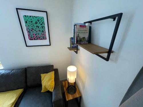 a living room with a couch and a mirror at Apartmány U Medvěda in Horní Blatná