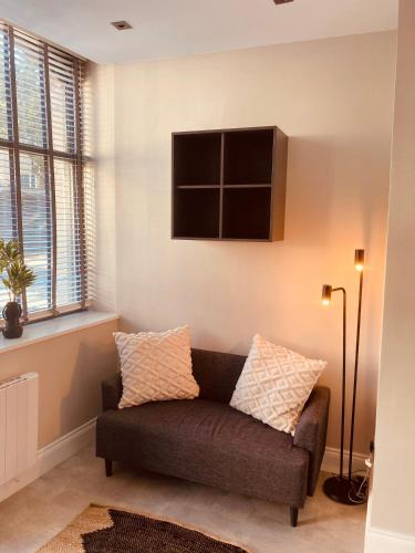 a living room with a couch and a tv on the wall at 'Fairfield' at stayBOOM in Lancaster