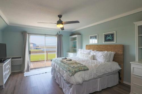 a bedroom with a large bed and a window at Come Stay - and Sail Away - at this Lovely Canal Home in Freeport