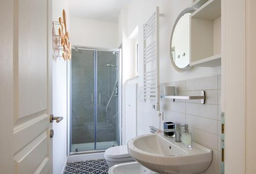 a bathroom with a sink and a toilet and a shower at TerraCieloMare Apartments in Monopoli