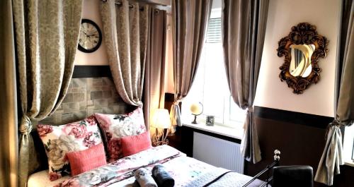a bedroom with a bed with pink pillows and a window at Art Apartments in Poznań