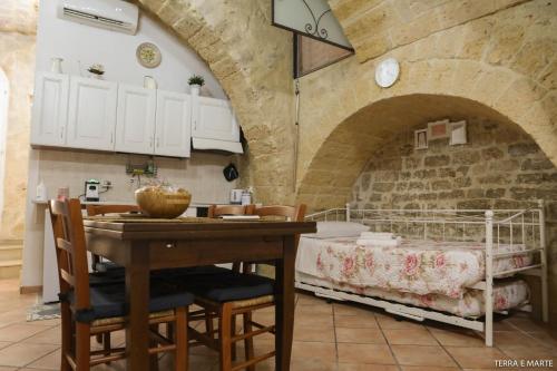 een keuken met een tafel en een bed in een kamer bij Terra e Marte casa vacanza in Bari