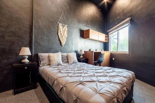 a bedroom with a large bed and a window at VILLA CHLOE. Modern 4 rooms house with pool in Cancún