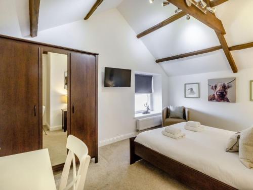 a bedroom with two beds and a table and chairs at Queen Victoria Suite in Stanhope