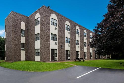a large brick building with a park in front of it at Best Western Glengarry in Truro