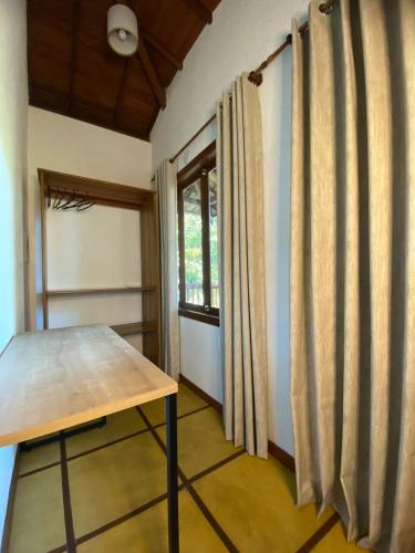 a room with a table and a window at Maui Suítes e Chalés in Arraial d'Ajuda