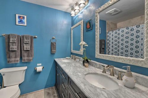 a blue bathroom with a sink and a toilet at Ocean-View Condo Less Than Half Mile to Kalapaki Beach! in Lihue