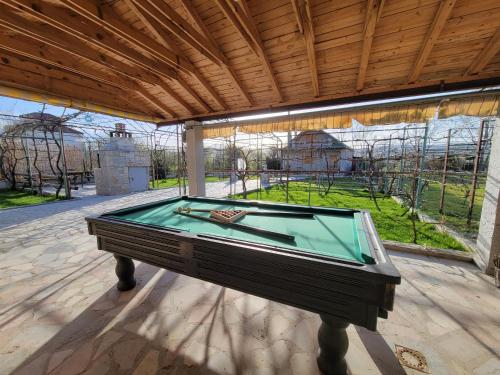a pool table in a pavilion on a patio at The Village House in Korçë
