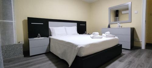 a bedroom with a large bed with towels on it at RUFIESCA in Torre de Moncorvo