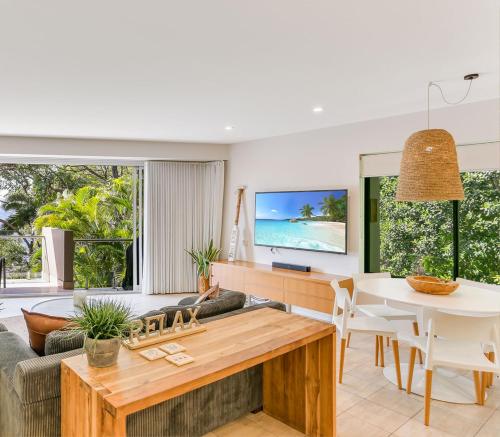 a living room with a couch and a table at Little Cove Court - Apartment 11 in Noosa Heads