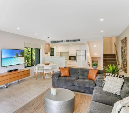 a living room with a couch and a table at Little Cove Court - Apartment 11 in Noosa Heads