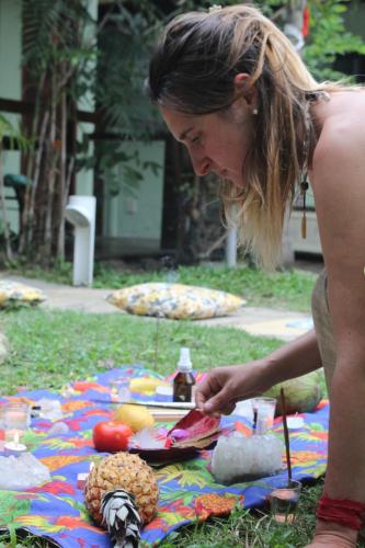 a woman standing in front of a picnic blanket at POUSADA ENCANTO DO AMOR in Búzios