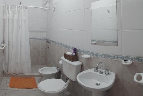 Baño blanco con aseo y lavamanos en Alquiler por día Choele Choel 3 en Choele Choel