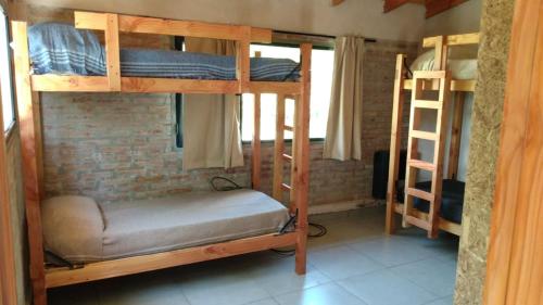 a room with two bunk beds in a room at PUERTO HOSTEL in El Hoyo