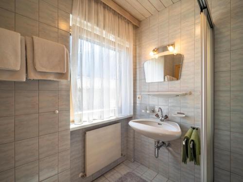 a bathroom with a sink and a mirror and a window at Panorama I in Mayrhofen