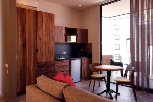a living room with a couch and a table at El Callejón Hotel Boutique in Oaxaca City