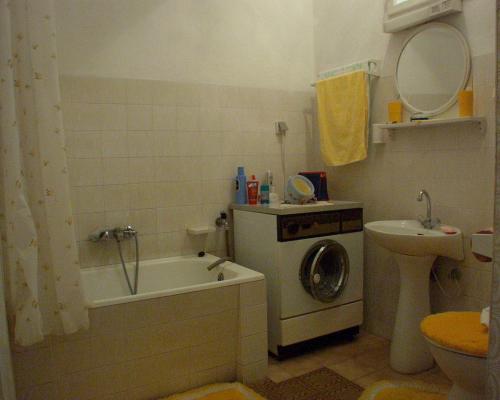 a bathroom with a washing machine and a sink at Apartments by the sea Povlja, Brac - 710 in Povlja