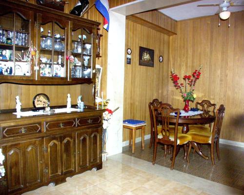 a dining room with a table and a wooden cabinet at Apartments by the sea Povlja, Brac - 710 in Povlja