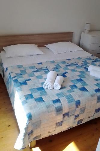 a bed with two towels on top of it at Apartments by the sea Povlja, Brac - 712 in Povlja