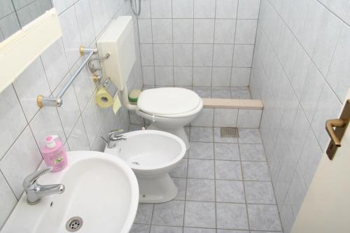 a small bathroom with a toilet and a sink at Apartments by the sea Povlja, Brac - 712 in Povlja