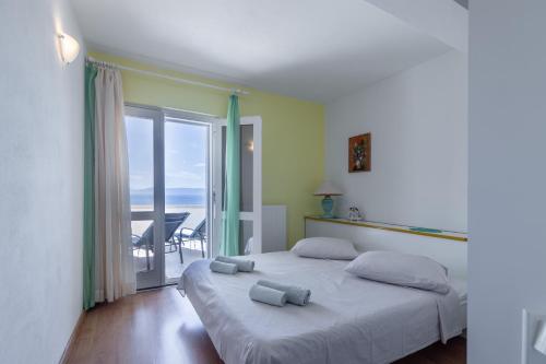 a bedroom with a bed with a view of the ocean at Apartments by the sea Puntinak, Brac - 718 in Selca