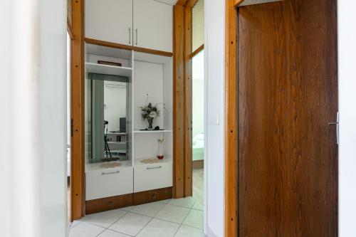 a hallway with a glass door with a vase in it at Apartments by the sea Puntinak, Brac - 718 in Selca