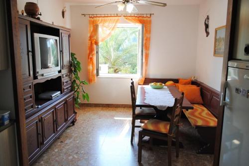 a living room with a table and a television at Apartments by the sea Milna, Brac - 733 in Milna