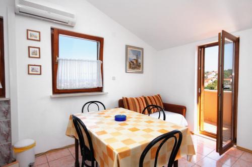 a dining room with a table and chairs and a window at Apartments with parking space Sutivan, Brac - 745 in Sutivan