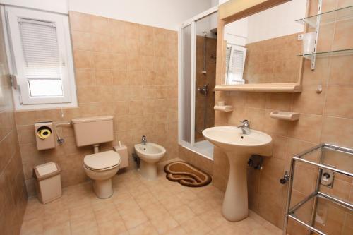 a bathroom with a toilet and a sink at Apartments by the sea Stomorska, Solta - 778 in Stomorska