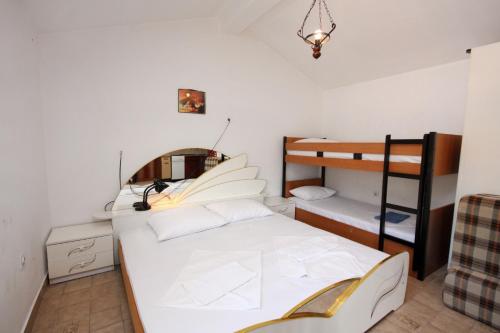 a bedroom with a bed and a bunk bed at Apartments by the sea Stomorska, Solta - 784 in Stomorska
