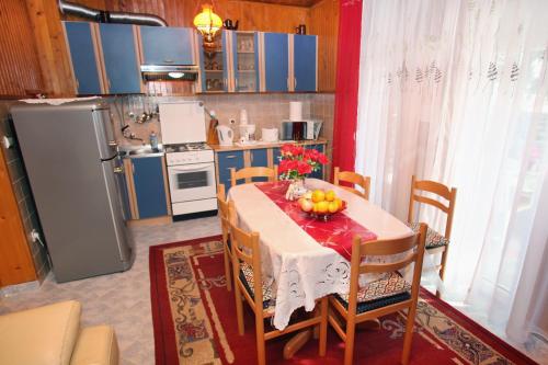 a kitchen with a table with fruit on it at Apartments by the sea Slatine, Ciovo - 972 in Trogir