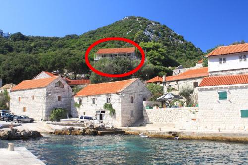 a red circle in the middle of a group of buildings at Apartments and rooms by the sea Lucica, Lastovo - 990 in Lastovo